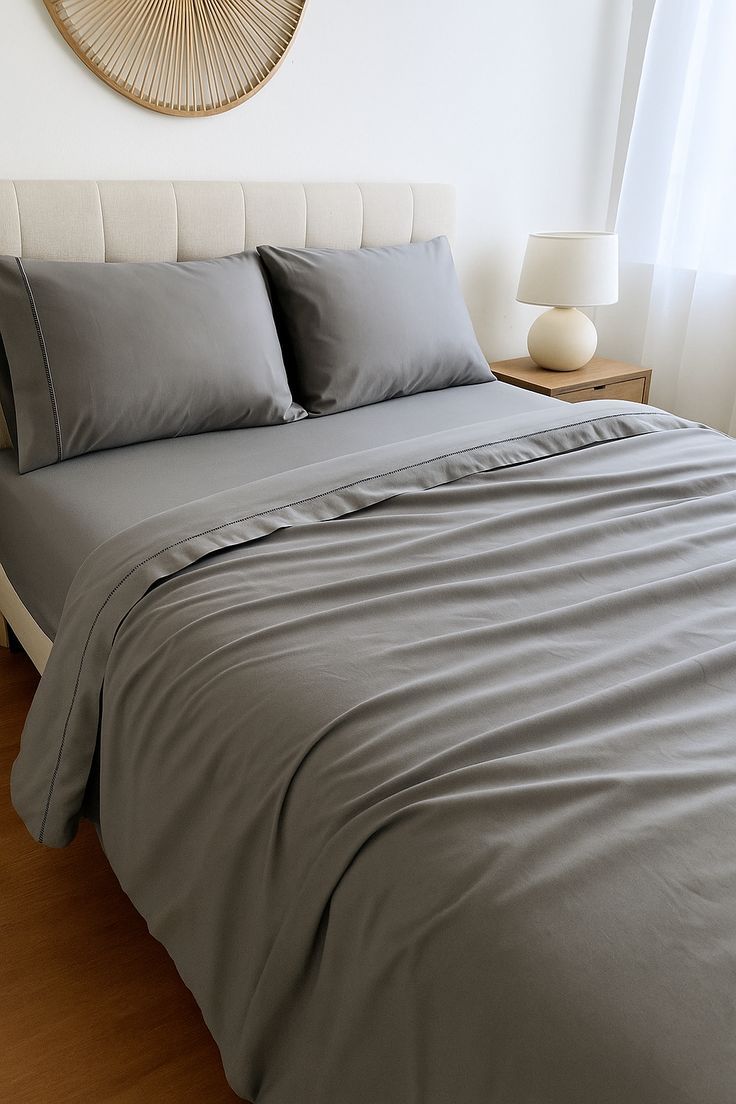 Grey cotton sheet set on a bed